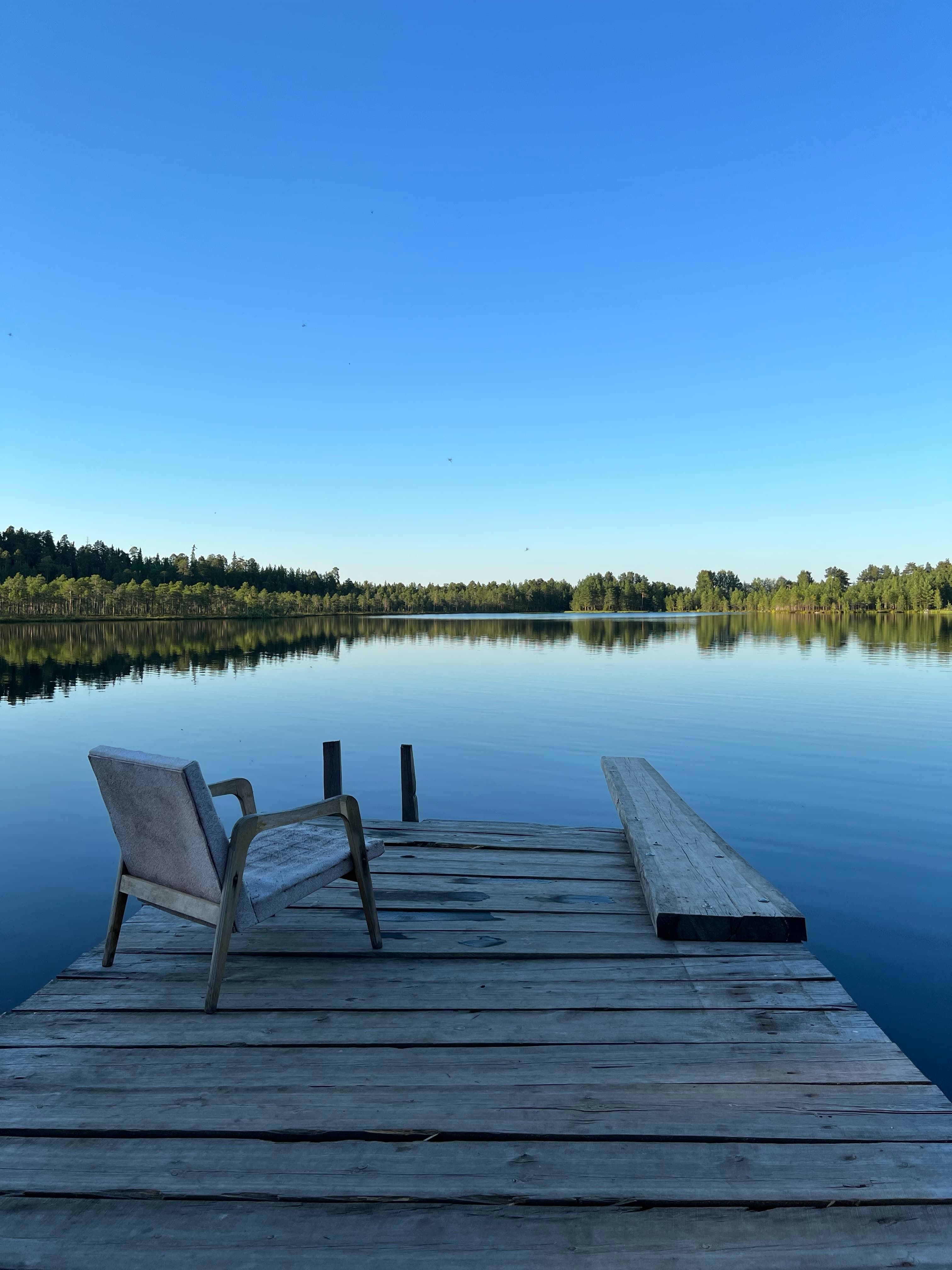 chair on a deck by the lake